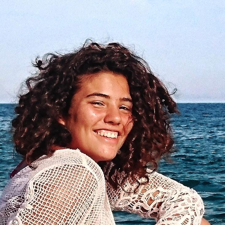 Nova Singh, Lead Design Curator at SpringWaterWorks, reviewing corporate floral arrangements